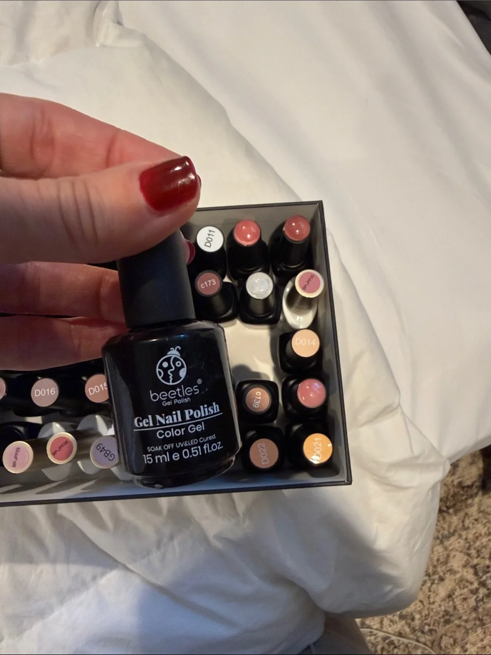 Collection of gel, nail polishes. Mostly light neutrals and dark neutrals.